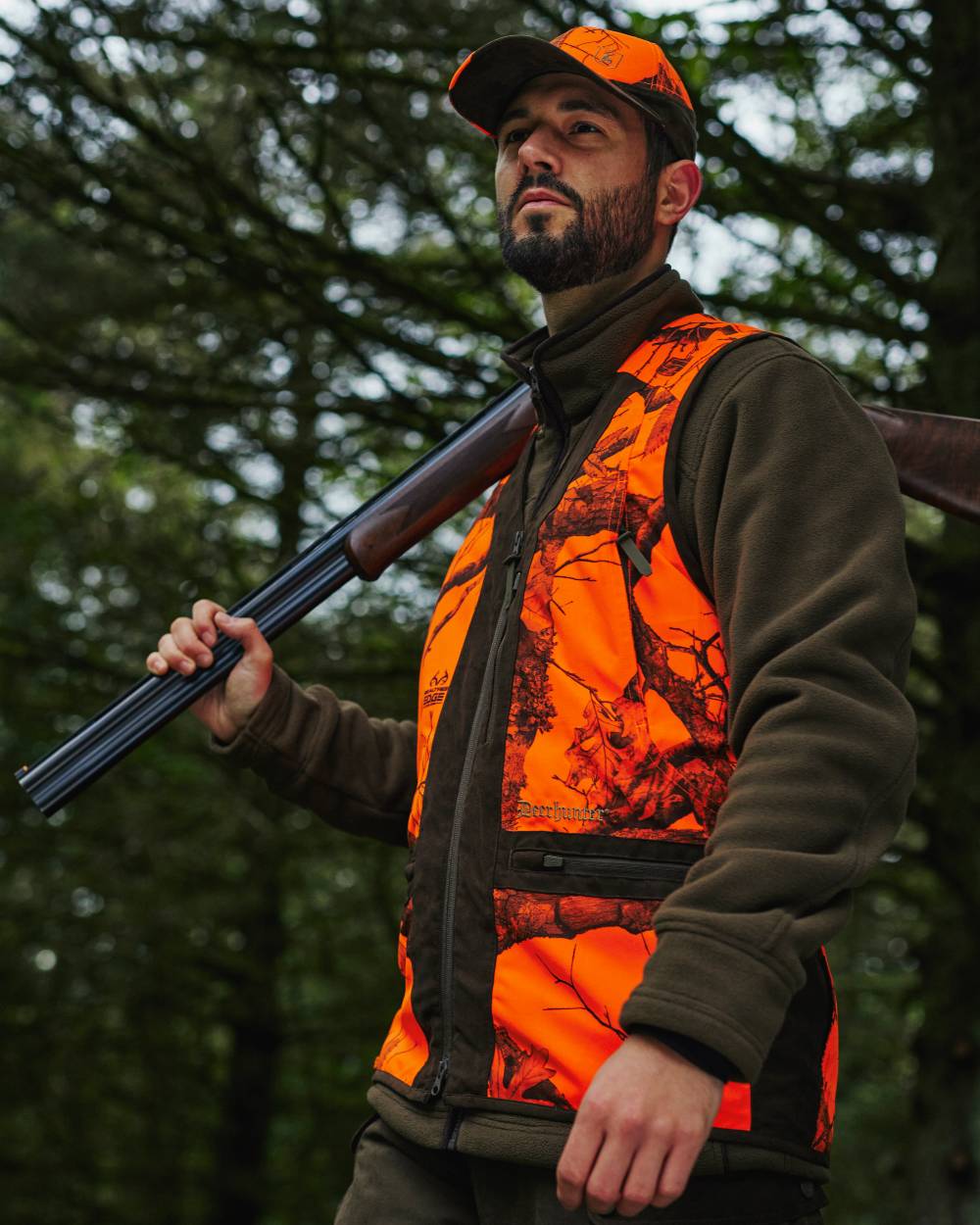 Realtree Edge Orange Coloured Deerhunter Eagle Waistcoat on forest background #colour_realtree-edge-orange