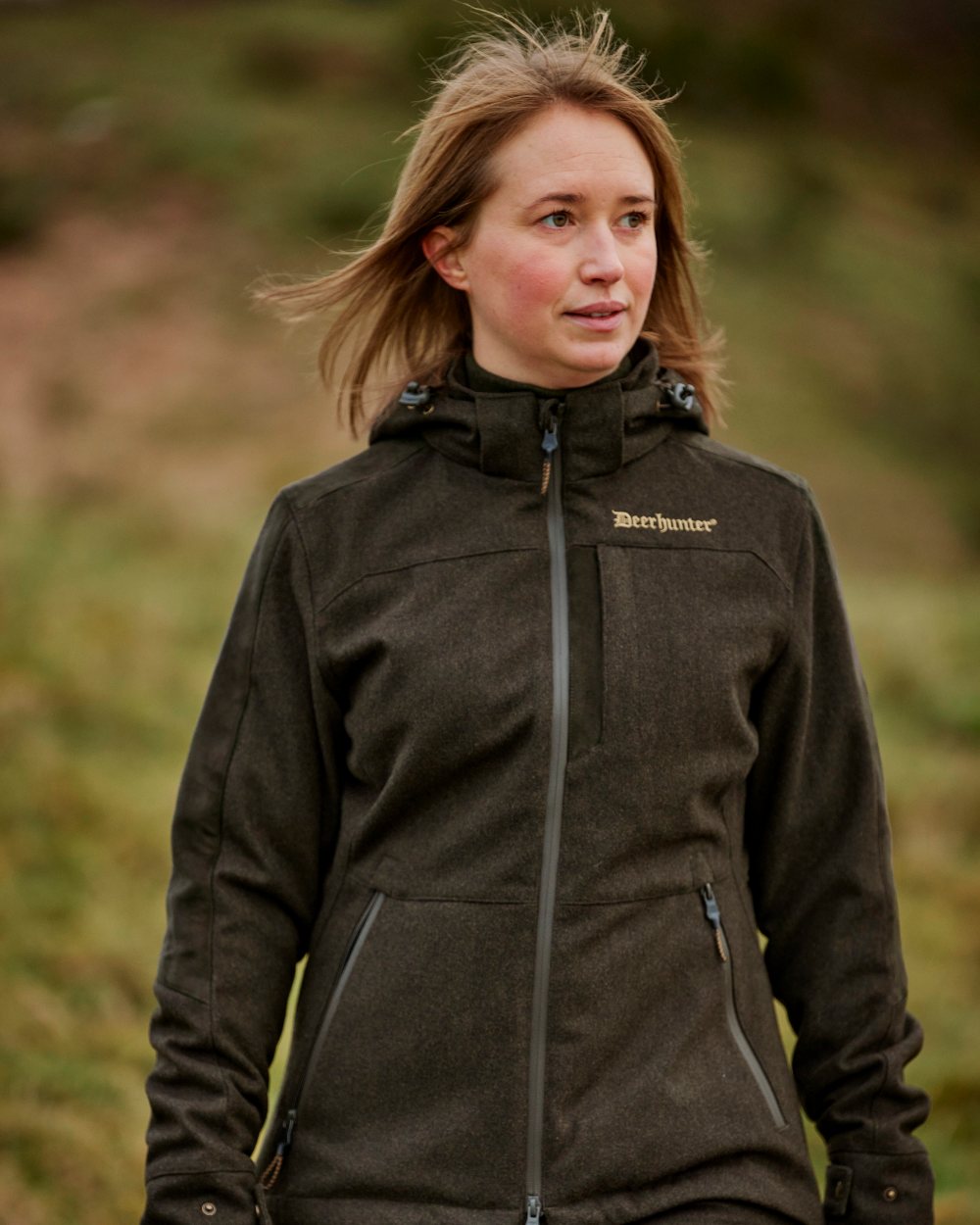 Loden Wood coloured Deerhunter Lady Tatra Active Jacket on Forest background #colour_loden-wood