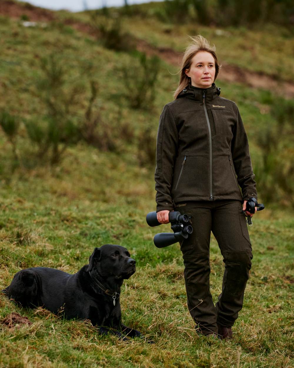 Loden Wood coloured Deerhunter Lady Tatra Active Jacket on Forest background #colour_loden-wood