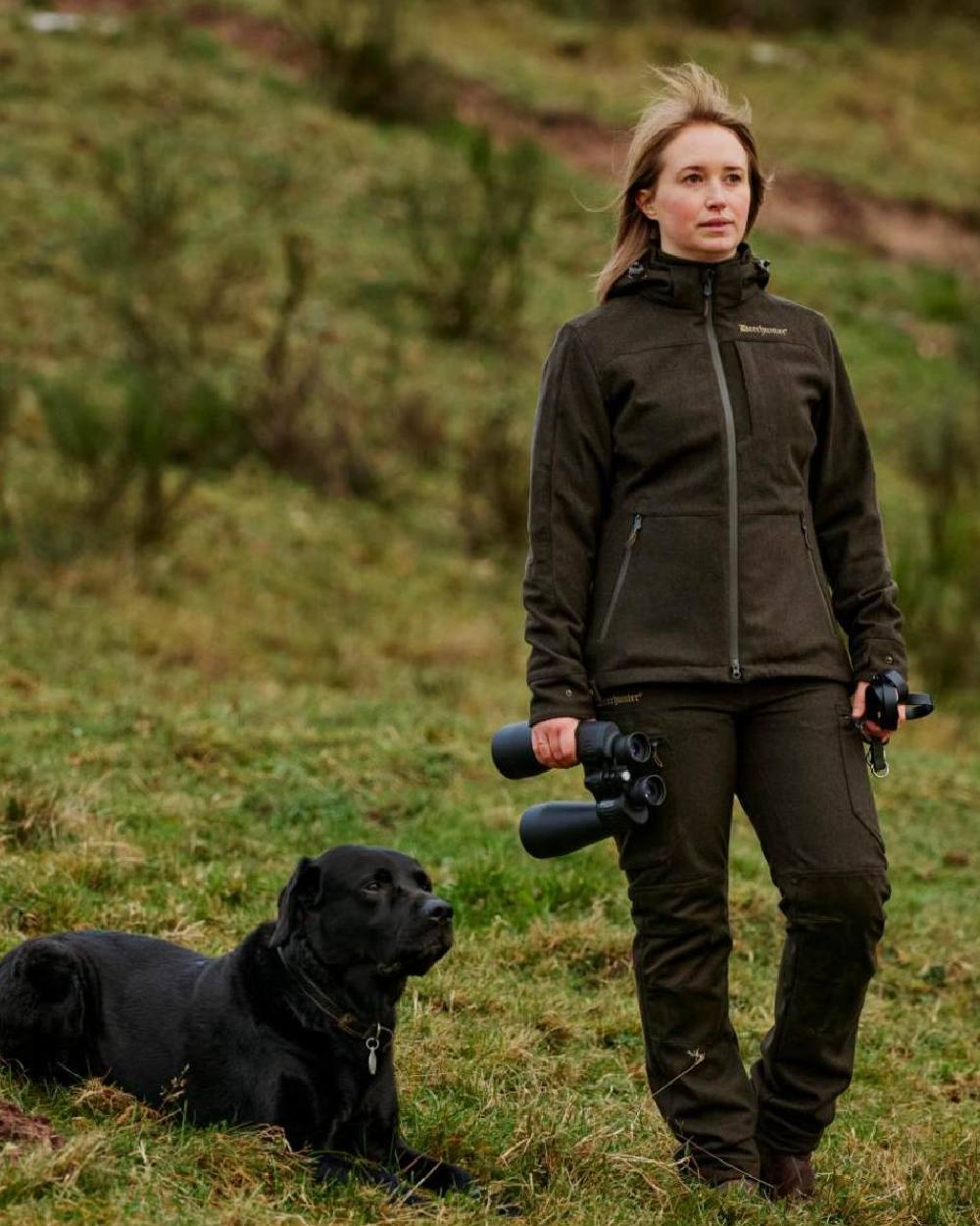 Loden Wood Deerhunter Lady Tatra Trousers on grassy background #colour_loden-wood