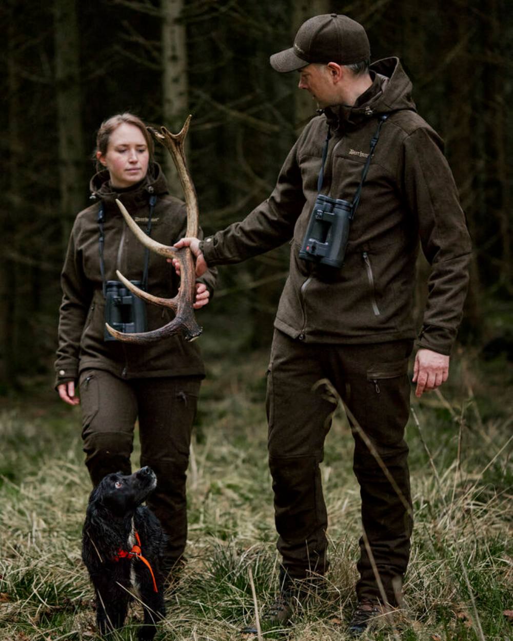 Loden Wood Deerhunter Lady Tatra Trousers on forest background #colour_loden-wood