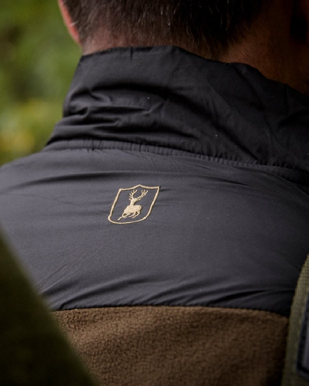 Chestnut Brown coloured Deerhunter Northward Fleece Jacket on blurry background #colour_chestnut-brown