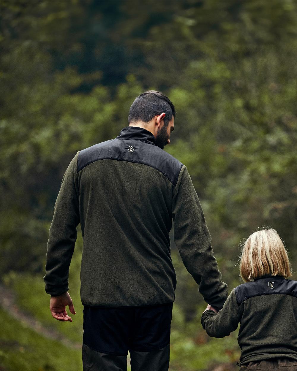 Bark Green Black coloured Deerhunter Northward Trousers on Forest Background #colour_bark-green-black