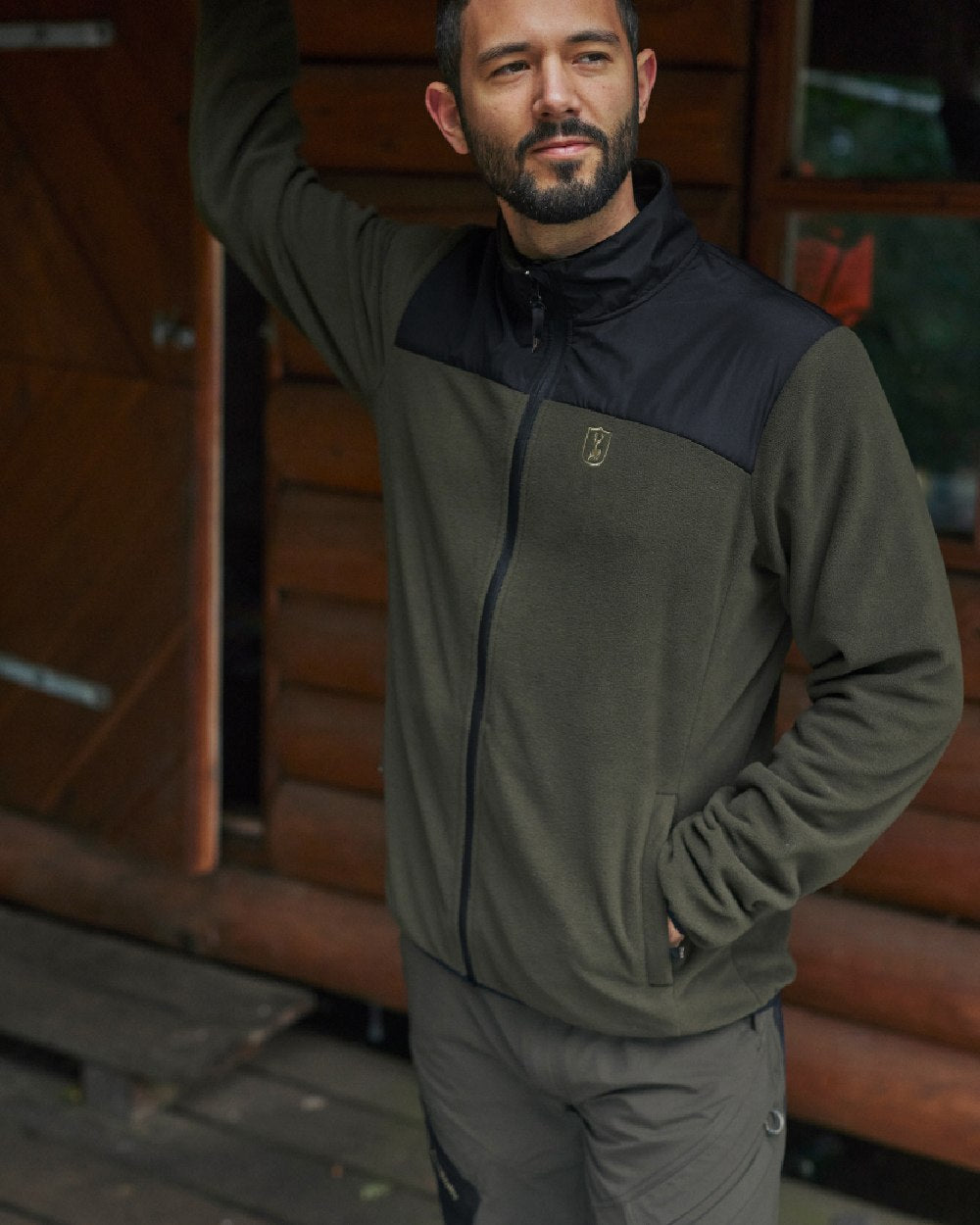 Bark Green Black coloured Deerhunter Northward Trousers on Wooden Background #colour_bark-green-black