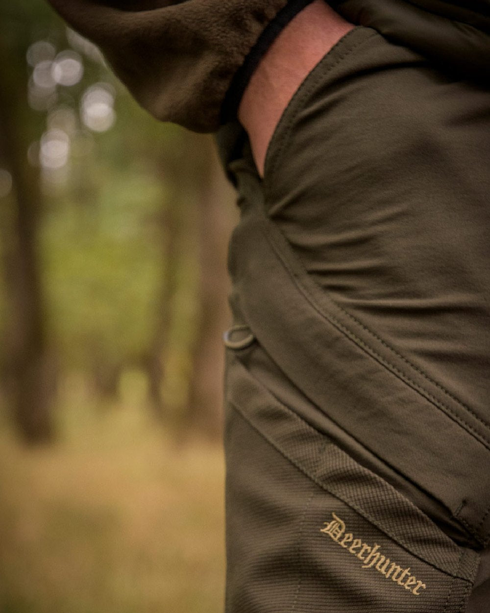 Bark Green coloured Deerhunter Northward Trousers on Blurry Background #colour_bark-green