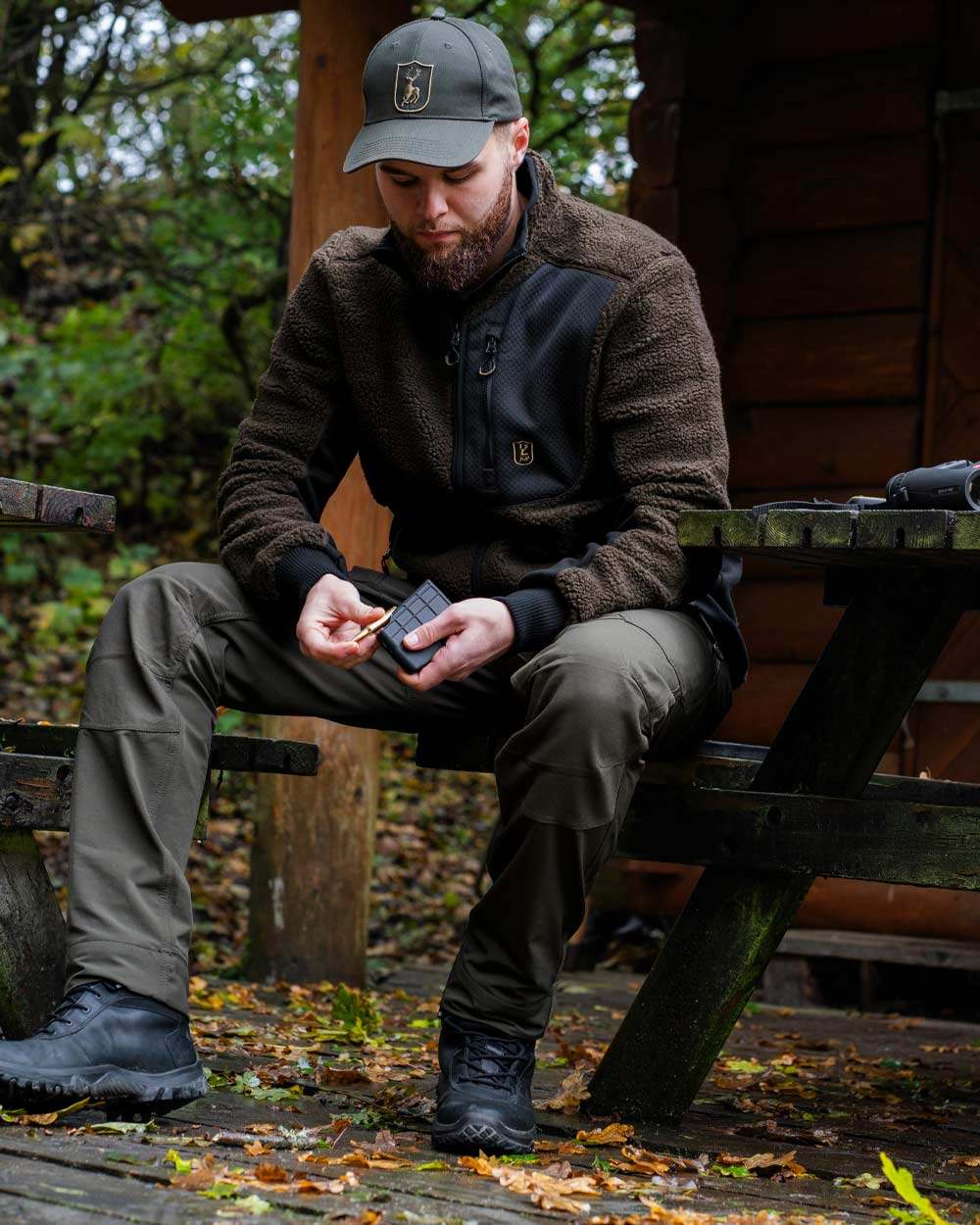 Bark Green coloured Deerhunter Northward Trousers on Forest Background #colour_bark-green