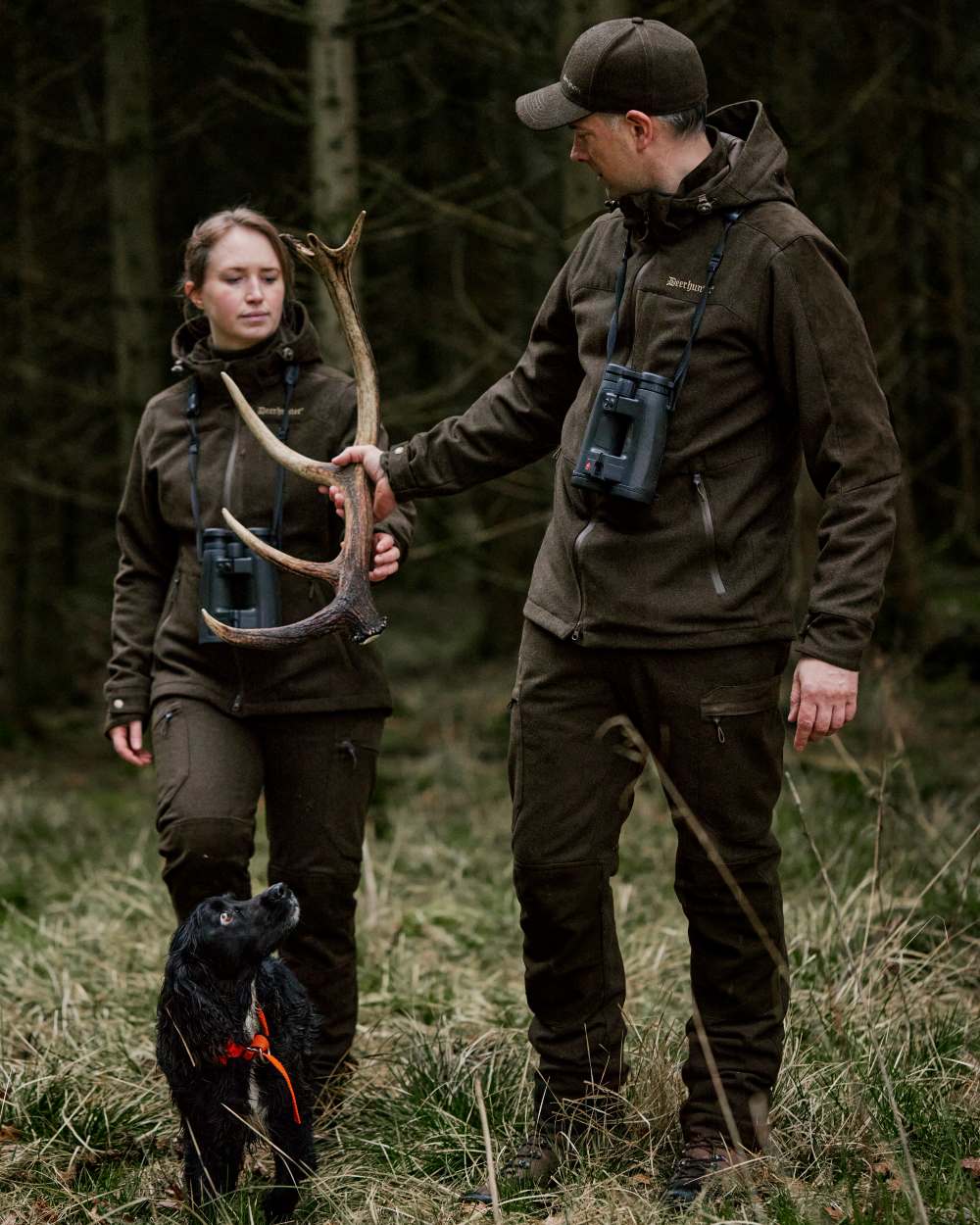 Loden Wood coloured Deerhunter Tatra Trousers on forest background #colour_loden-wood