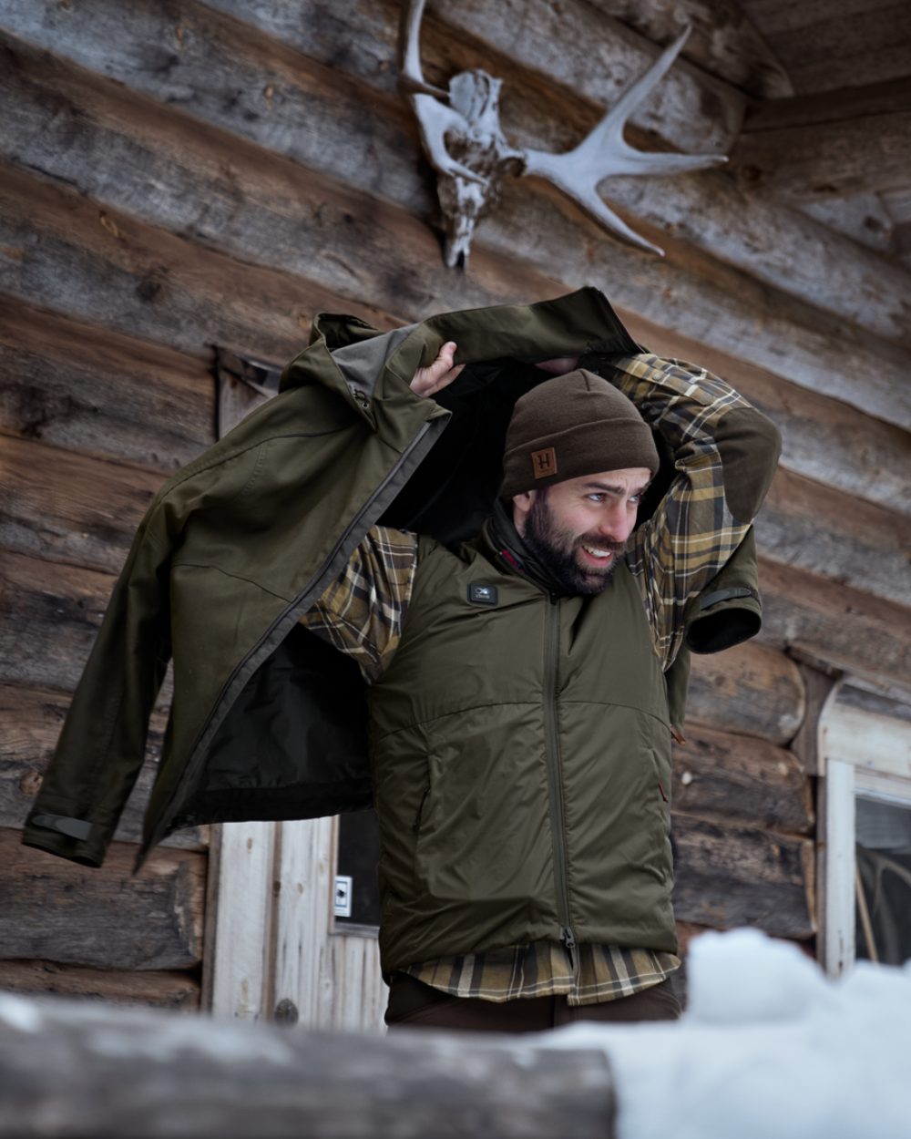 Willow Green Coloured Harkila Clim8 Base Waistcoat on house background #colour_willow-green