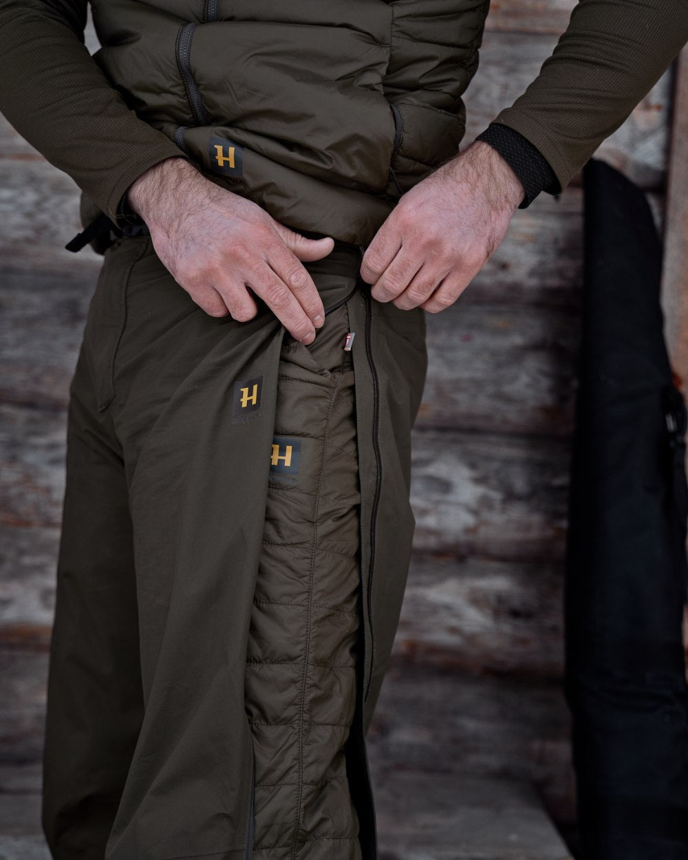Willow Green Coloured Harkila Logmar Insulated Packable Knee Breeches On A Wooden House Background