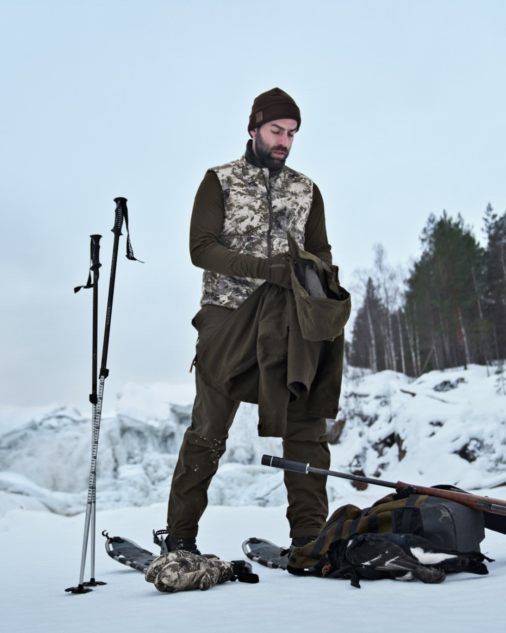 AXIS Mountain Coloured Harkila Camo HSP Insulated Waistcoat on snow background #colour_axis-mountain