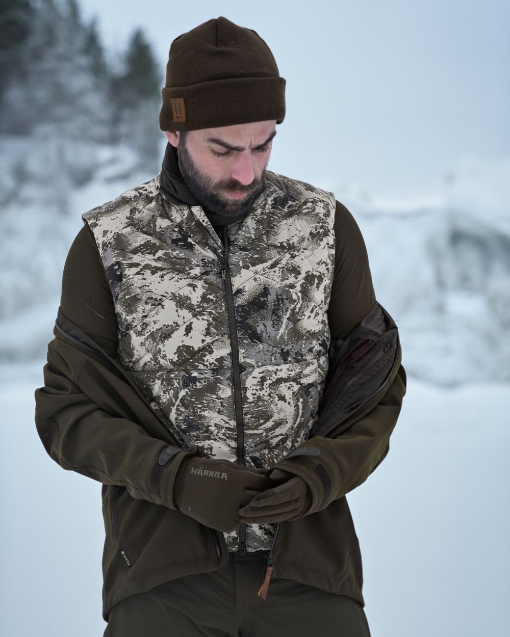 AXIS Mountain Coloured Harkila Camo HSP Insulated Waistcoat on snow background #colour_axis-mountain