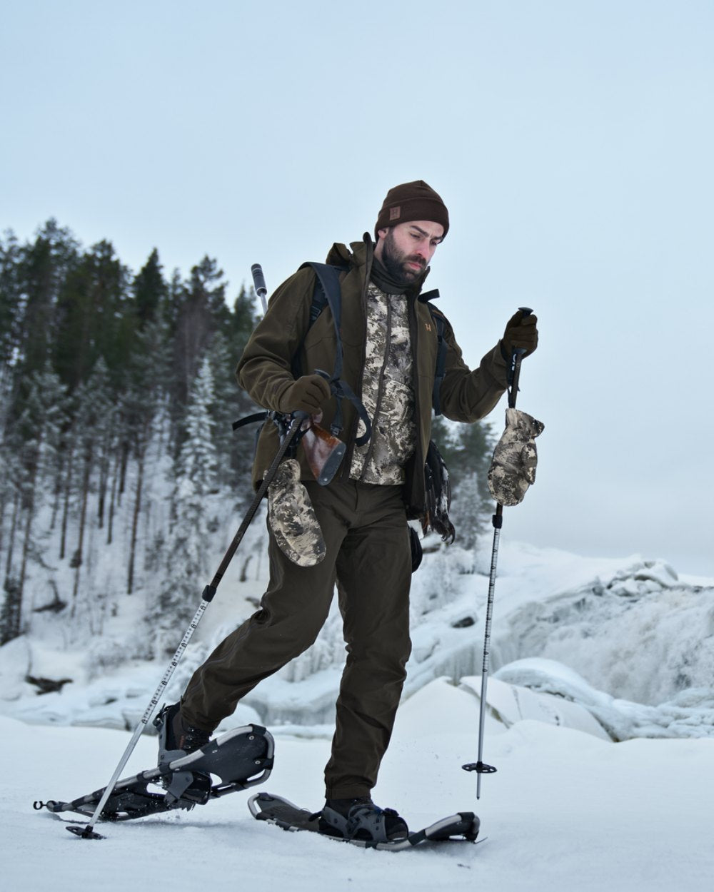 AXIS Mountain Coloured Harkila Camo HSP Insulated Waistcoat on snow background #colour_axis-mountain