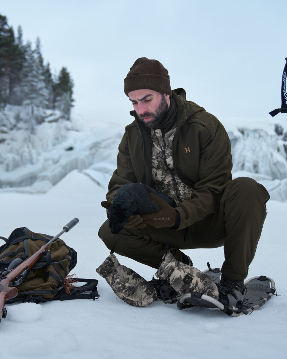 AXIS Mountain Coloured Harkila Camo HSP Insulated Waistcoat on snow background #colour_axis-mountain