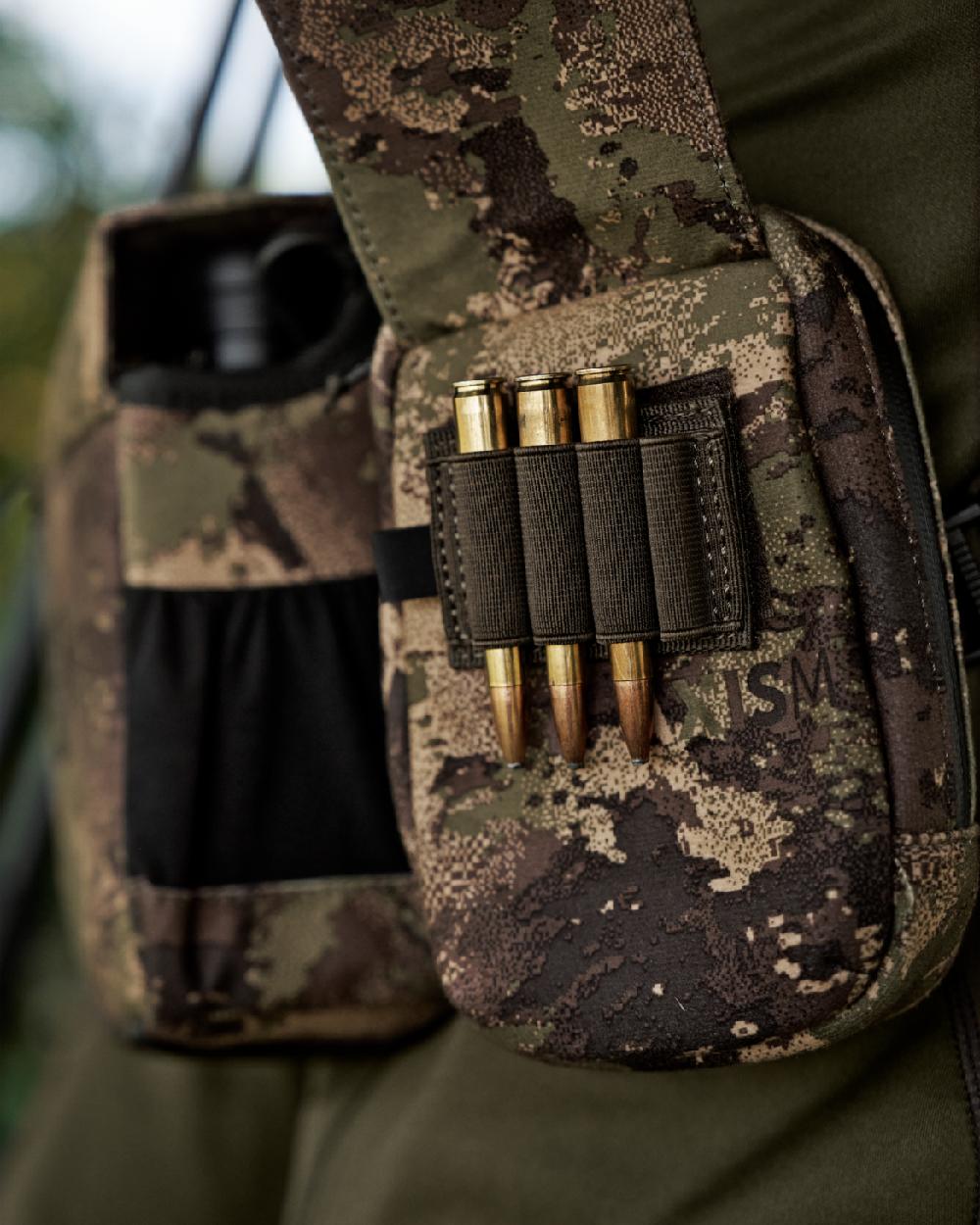 AXIS MSPForest Coloured Harkila Utility Camo Pouch on blurry background #colour_axis-mspforest