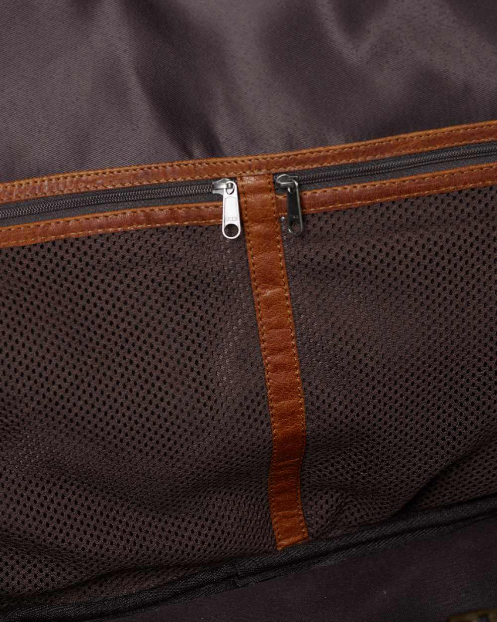 Warm Olive Coloured Harkila Weekend Bag 30L on blurry background #colour_warm-olive