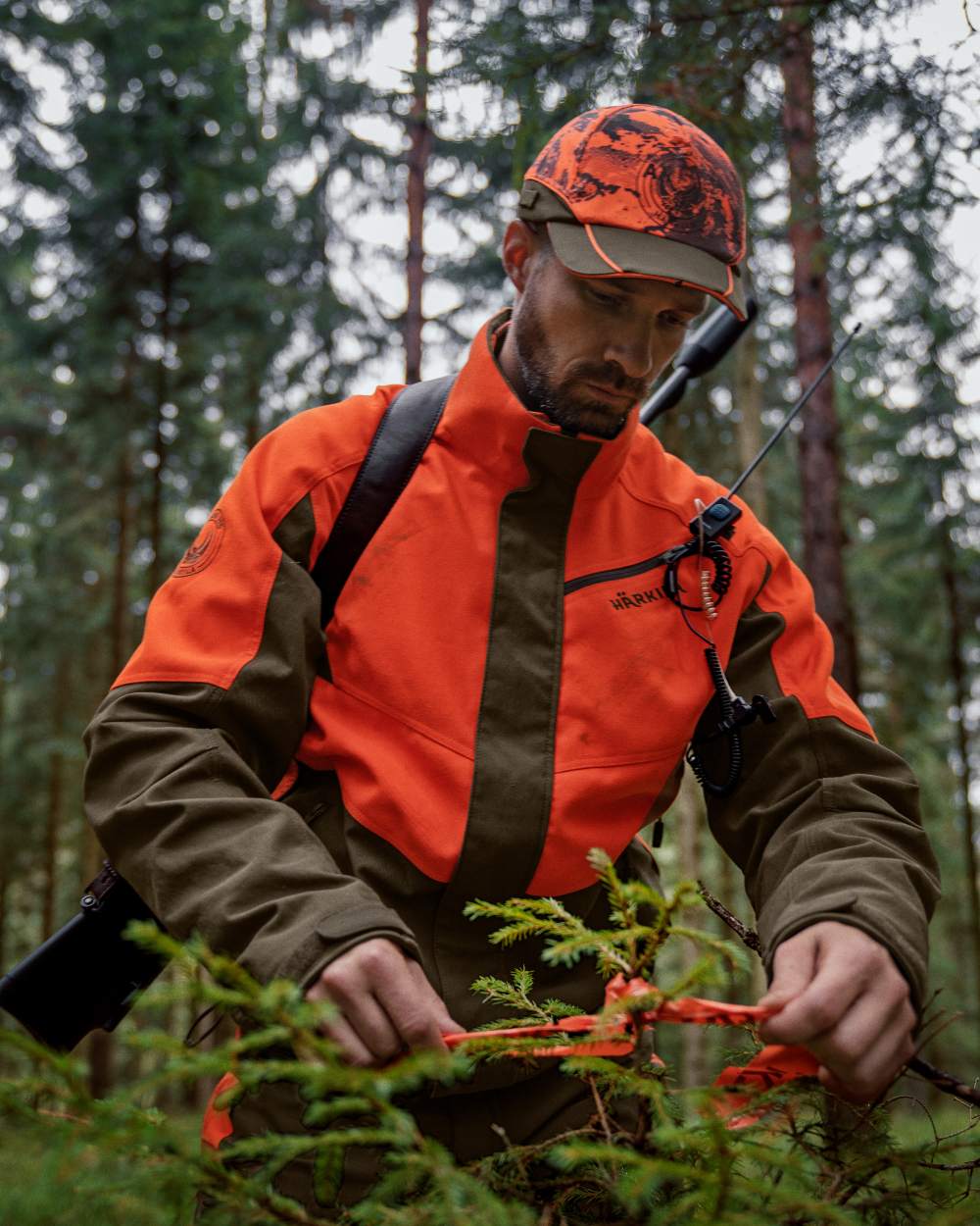 Wildboar Orange Willow Green Coloured Harkila Wildboar Pro Jacket on outdoor background #colour_wildboar-orange-willow-green