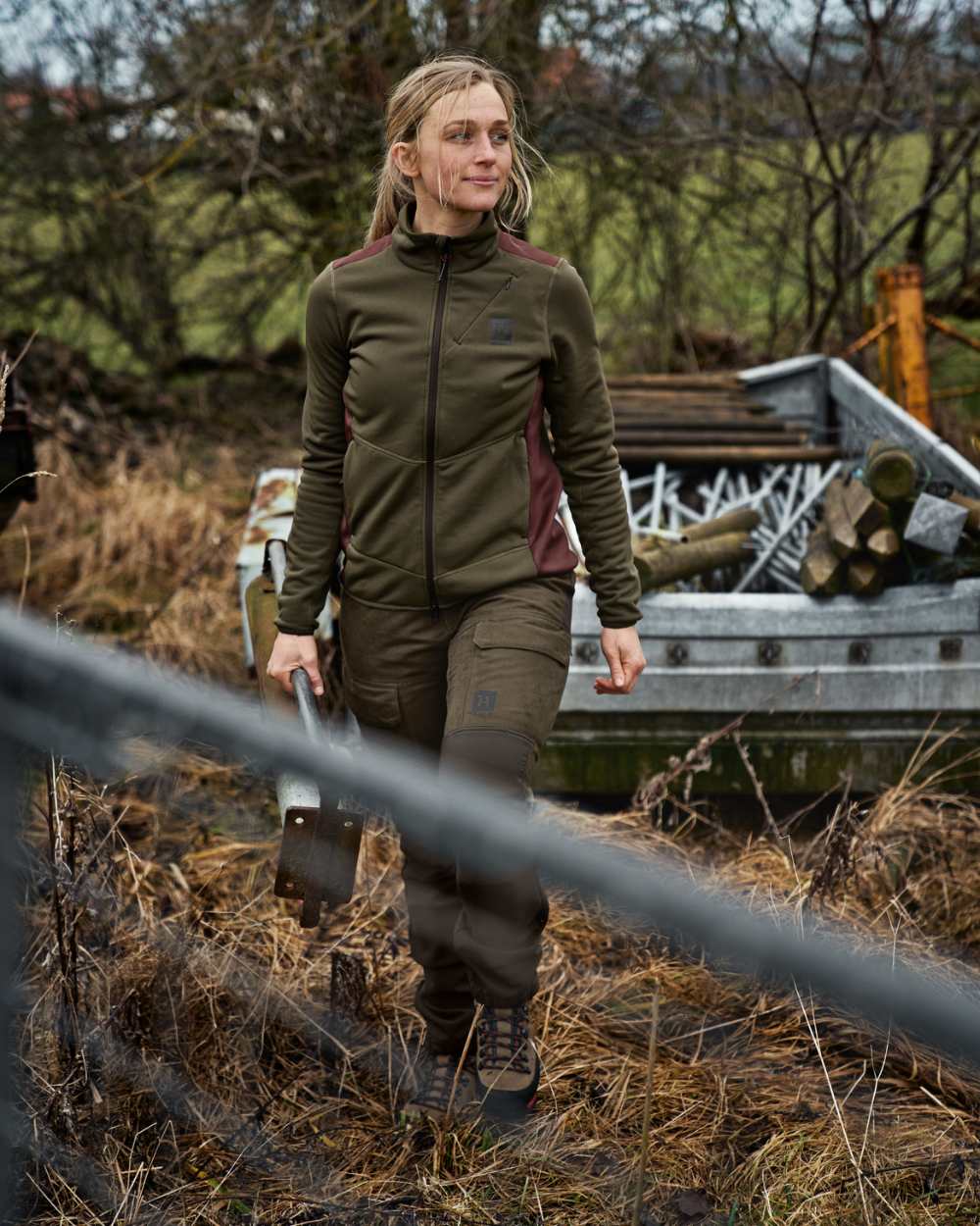 Willow Green Deep Brown Coloured Harkila Womens Scandinavian Pants On A Forest Background #colour_willow-green-deep-brown