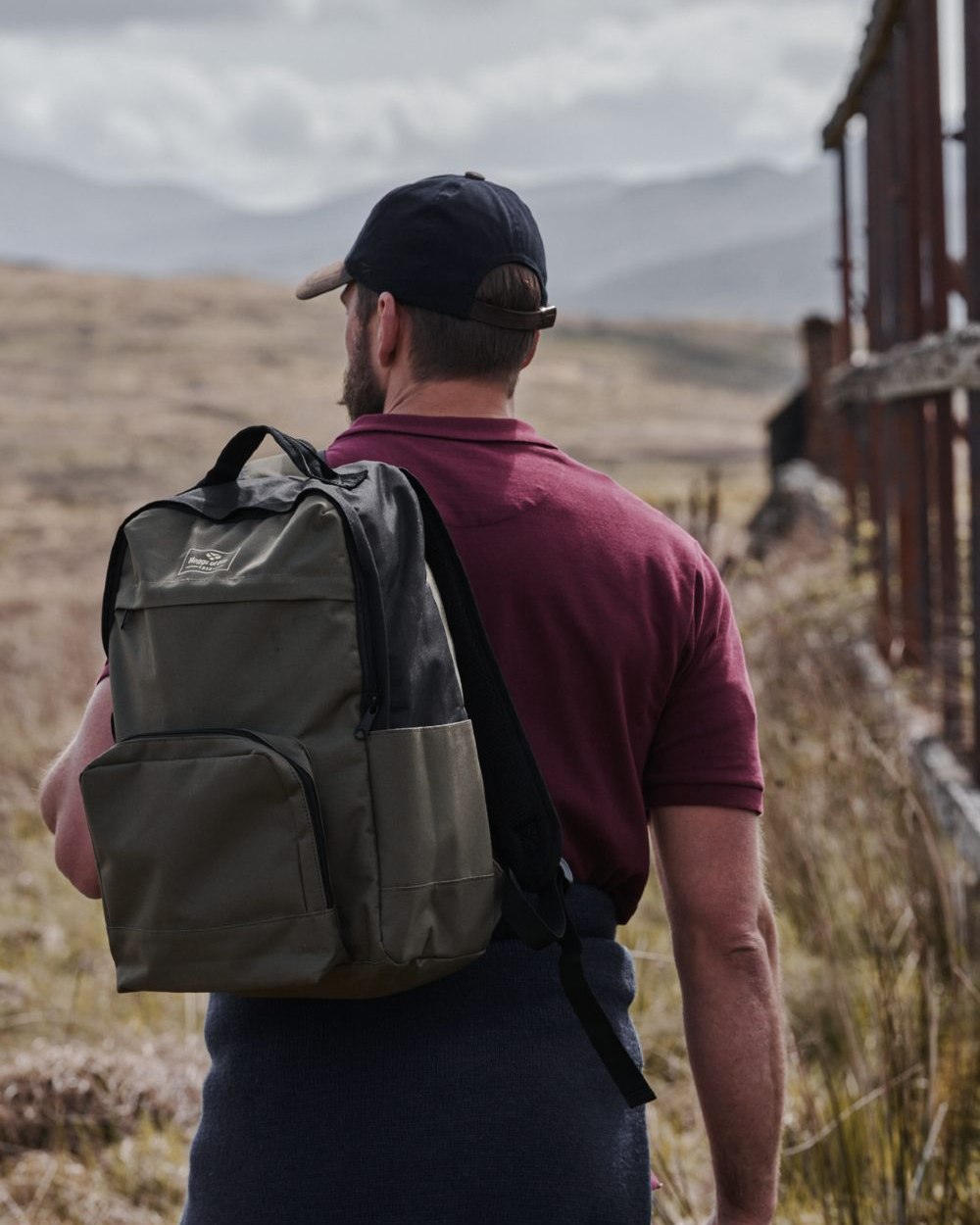 Green Black Coloured Hoggs of Fife Field & Trek Backpack on mountain background #colour_green-black