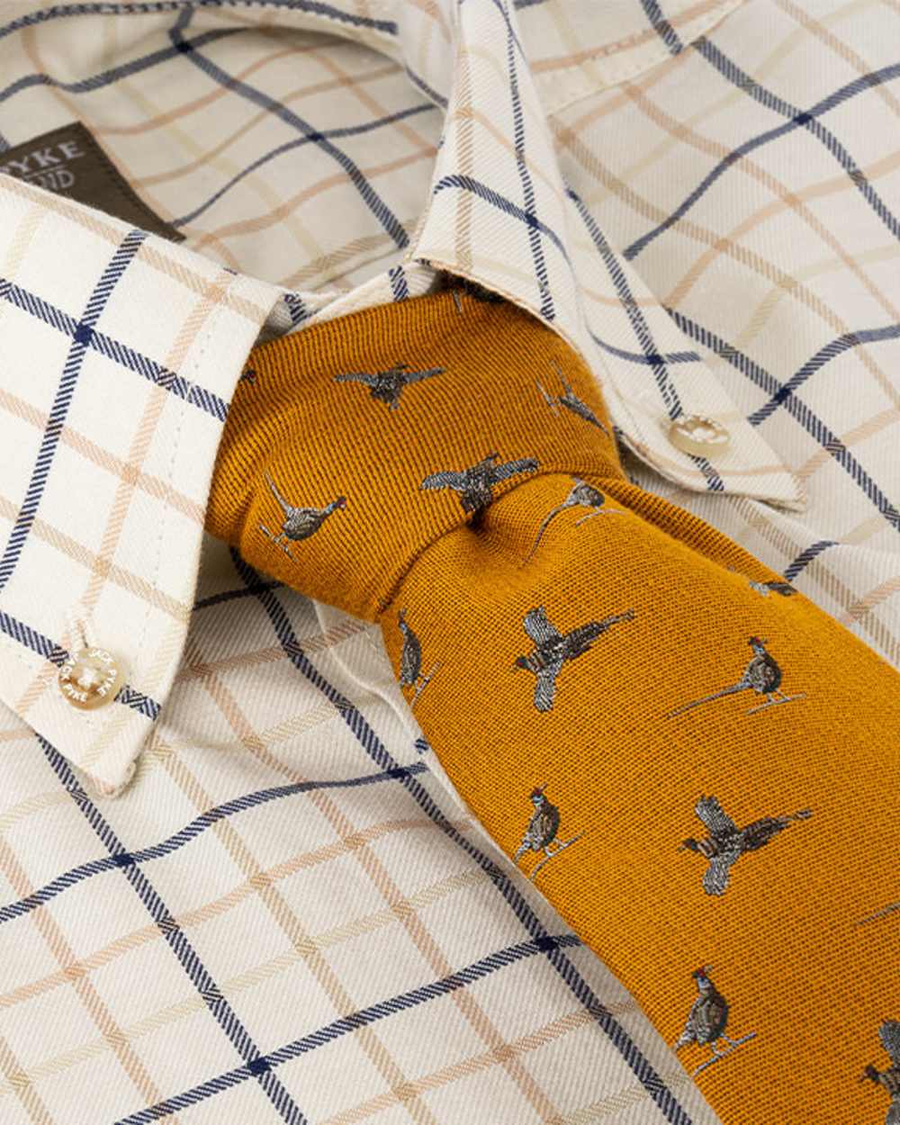 Mustard coloured Jack Pyke Silk Tie Pheasant on shirt background #colour_mustard