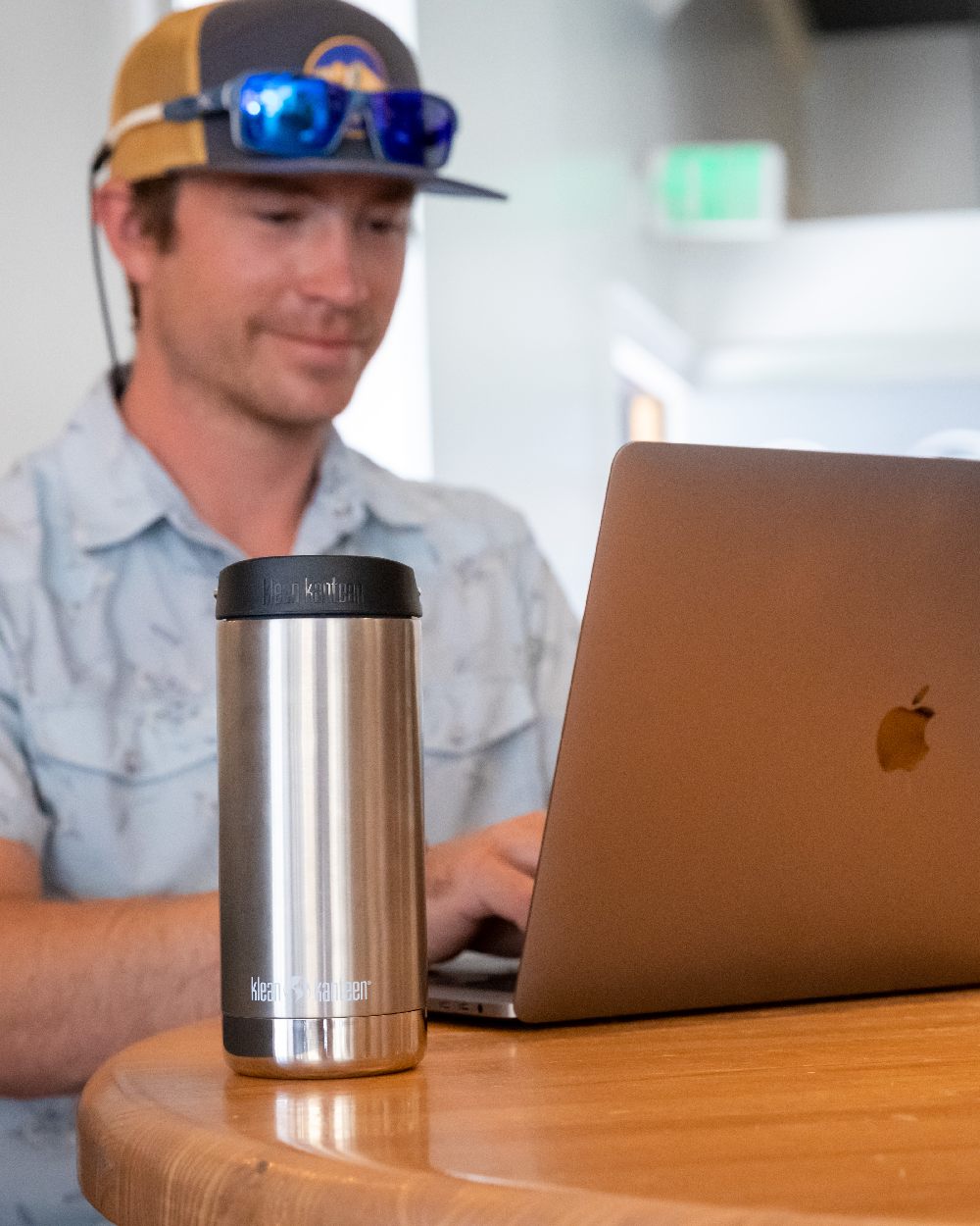 Brushed Stainless Coloured Klean Kanteen Insulated TKWide With Cafe Cap On A Desk Background #colour_brushed-stainless
