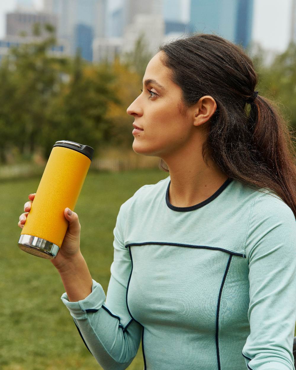 Marigold Coloured Klean Kanteen Insulated TKWide With Cafe Cap On A Garden Background #colour_marigold