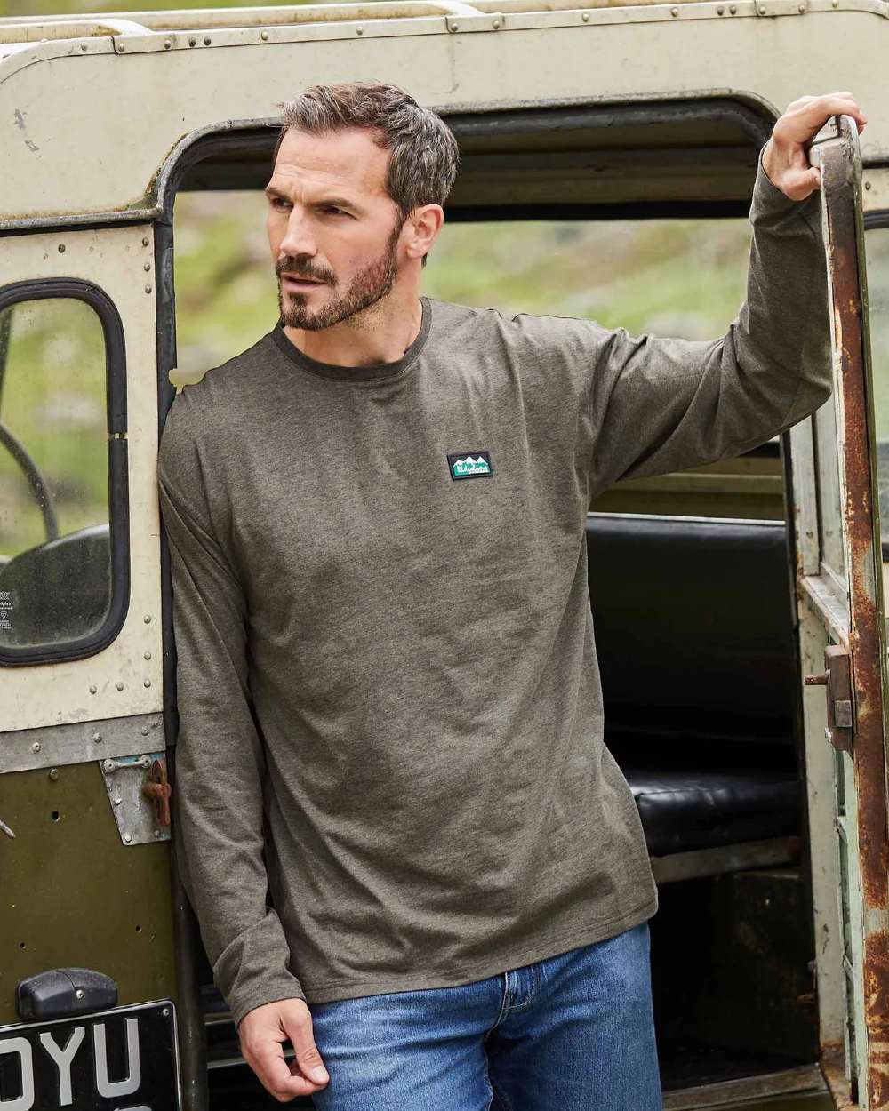 Smokey Olive Marl Coloured Ridgeline Mens Baseline Top On A Field Background #colour_smokey-olive-marl