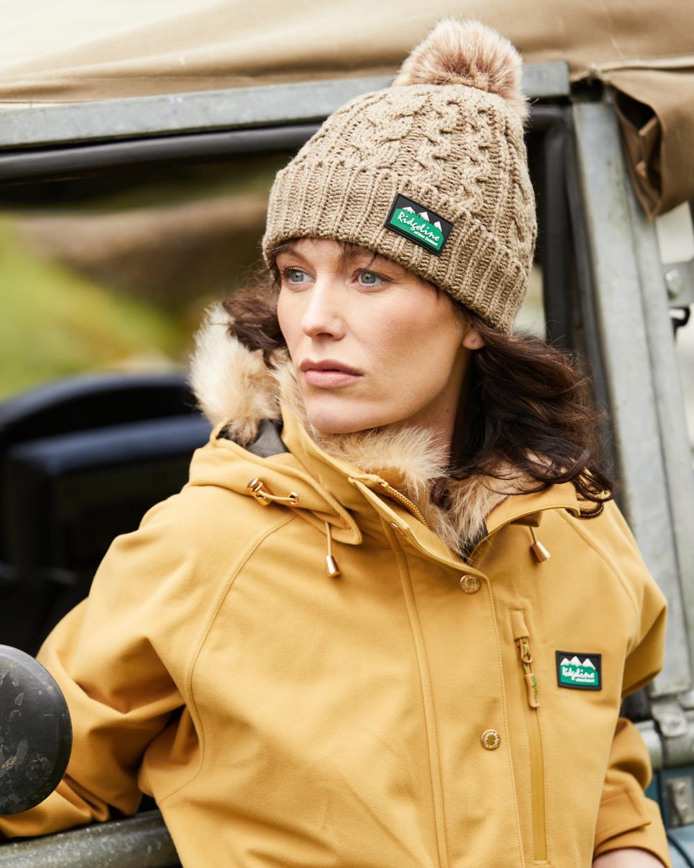 Teak Coloured Ridgeline Nordic Fleck Bobble Hat On A Forest Background #colour_teak