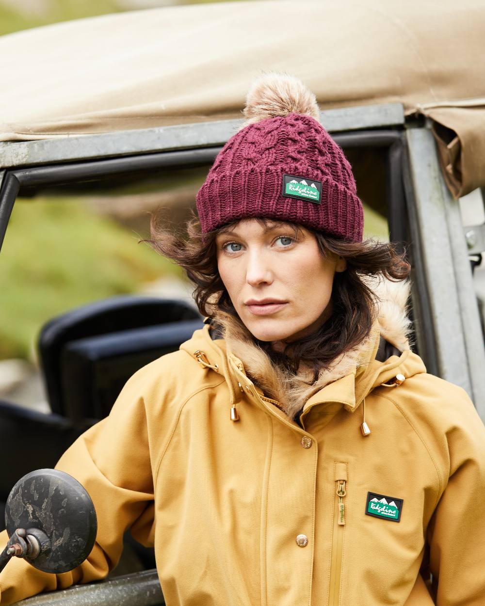 Winter Berry Coloured Ridgeline Nordic Fleck Bobble Hat On A Forest Background #colour_winter-berry