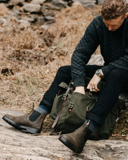 Dark Olive coloured Blundstone 1615 Classic Waxed Suede Chelsea Boots on forest background #colour_dark-olive