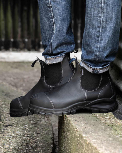 Black coloured Blundstone 910 Black Platinum Safety Boots on street background #colour_black