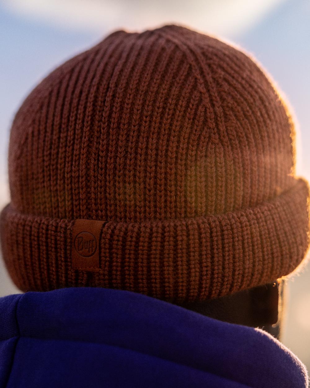 Cinnamon Coloured Buff Knitted Ervin Beanie on sky background #colour_cinnamon