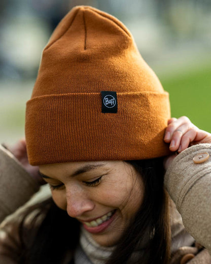 Copper Coloured Buff Linon Knitted Beanie on blurry background #colour_copper