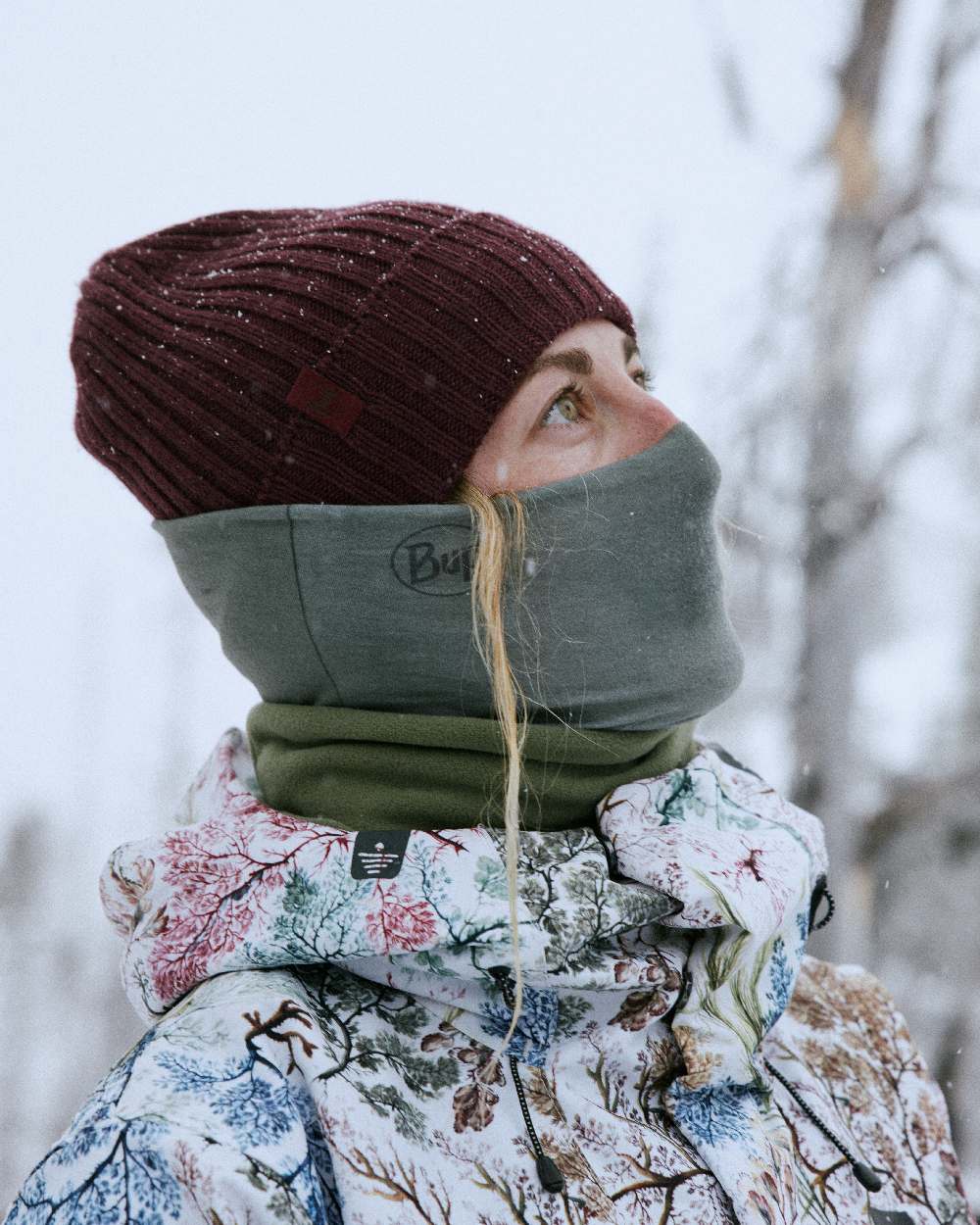 Maroon Coloured Buff Knitted Norval Beanie on snow background #colour_maroon
