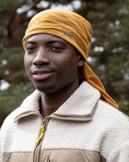 Mustard Coloured Buff Merino Lightweight Neck Warmer on outdoor background #colour_mustard