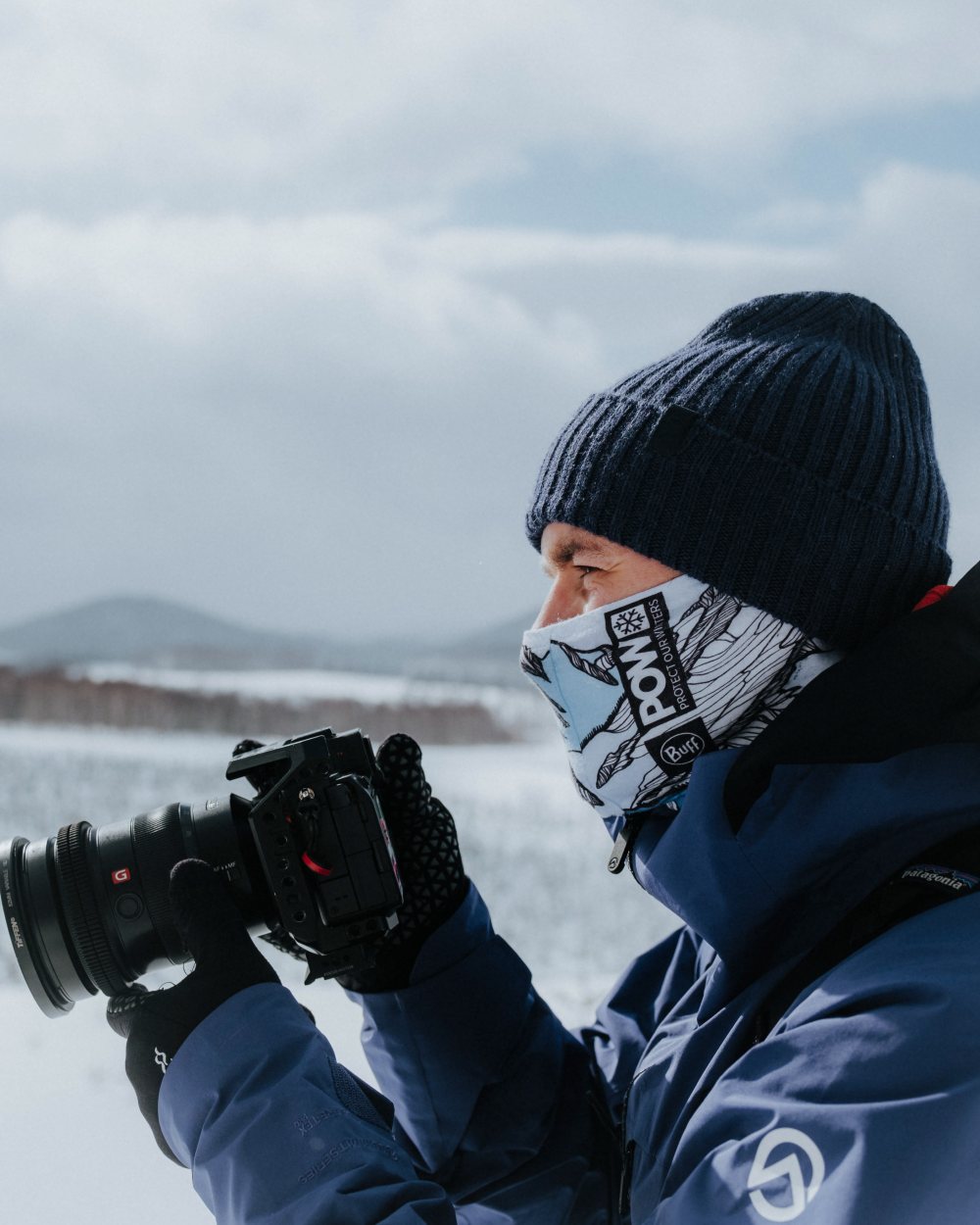 Midnight Coloured Buff Rutger Knitted Beanie on snow background #colour_midnight