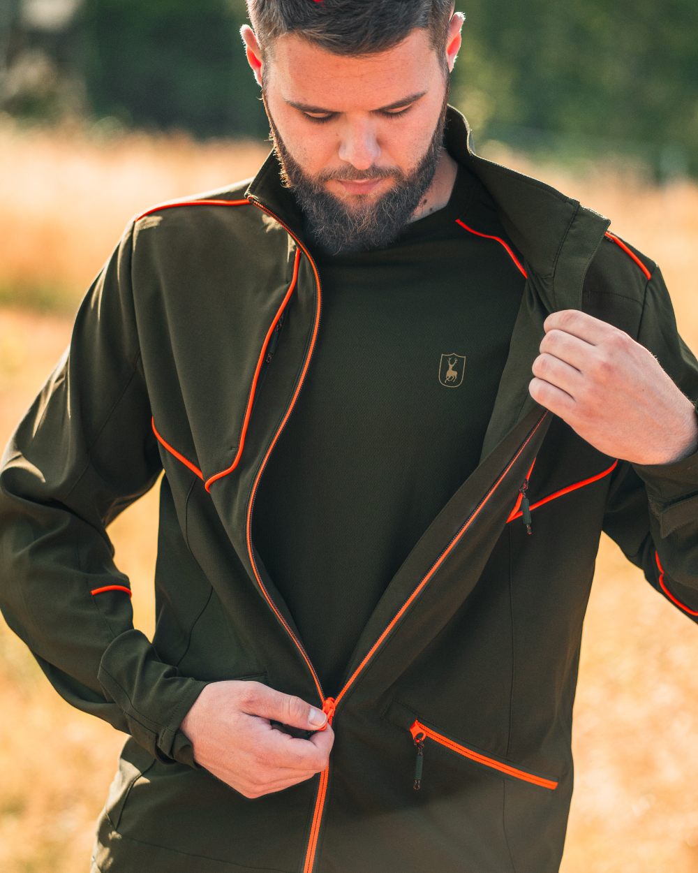 Forest Green coloured Deerhunter Chamois Jacket on forest background #colour_forest-green