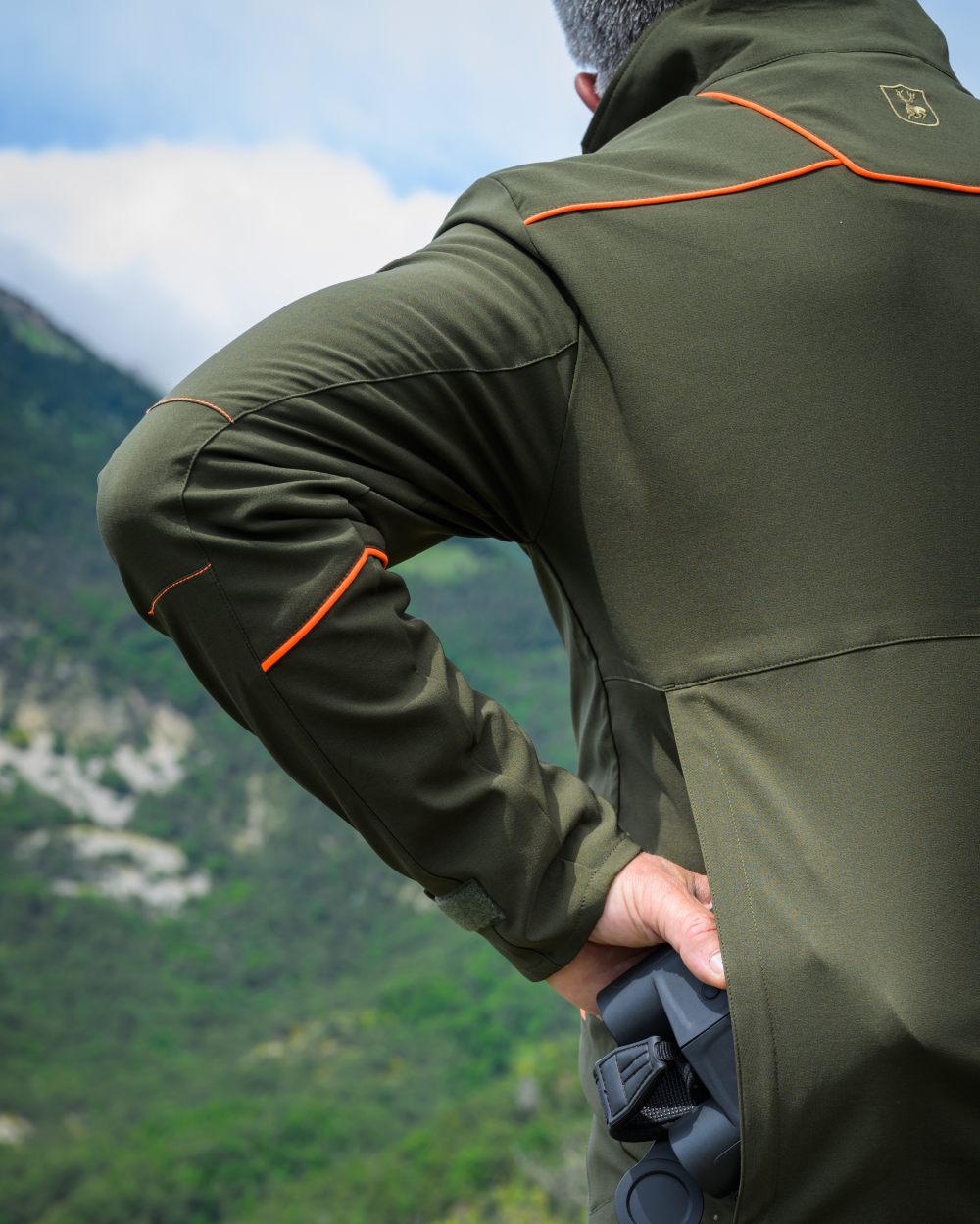 Forest Green coloured Deerhunter Chamois Jacket on forest background #colour_forest-green