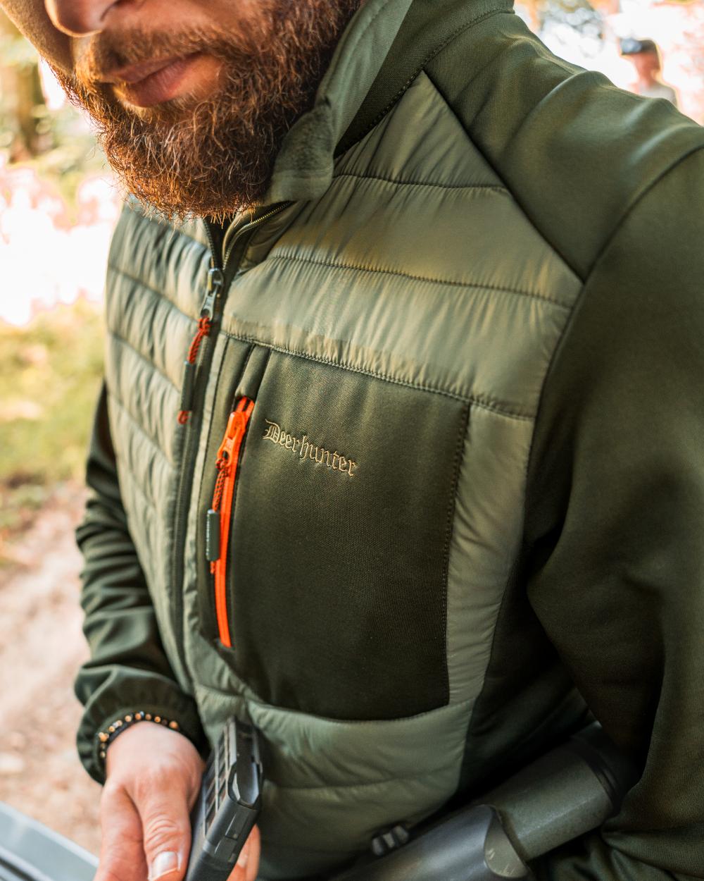 Forest Green coloured Deerhunter Chamois Padded Jacket on forest background #colour_forest-green
