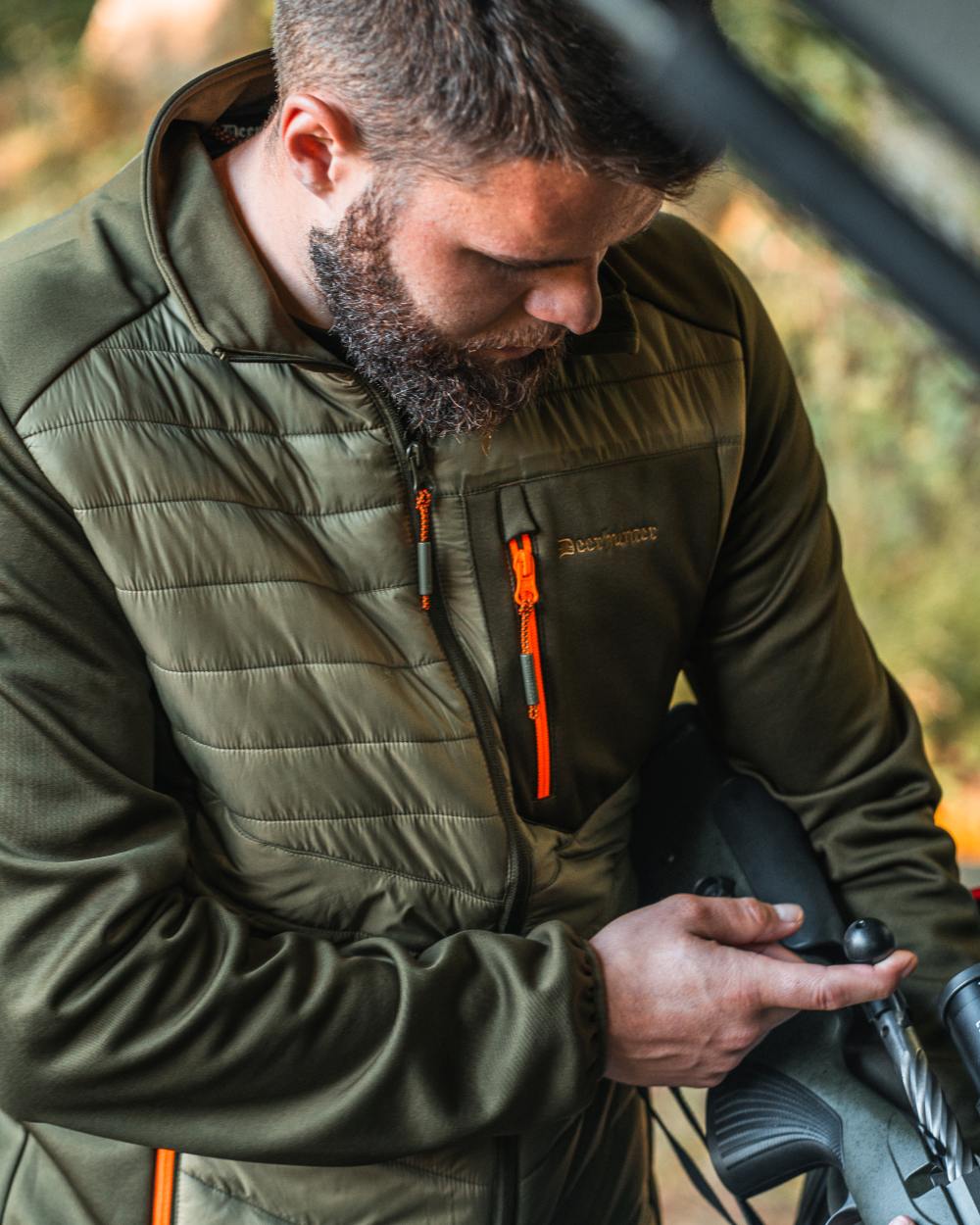 Forest Green coloured Deerhunter Chamois Padded Jacket on forest background #colour_forest-green