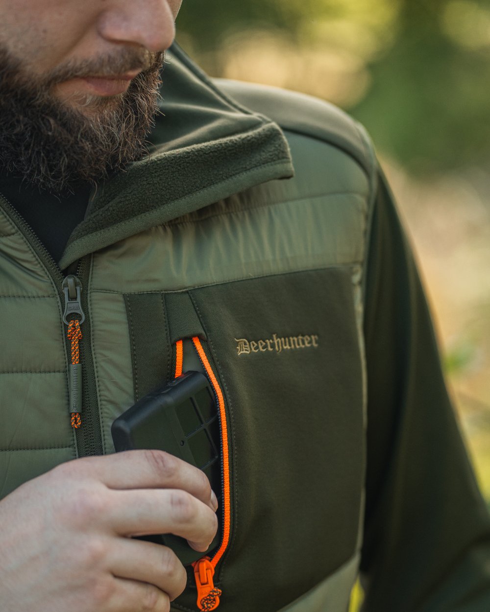 Forest Green coloured Deerhunter Chamois Padded Waistcoat on forest background #colour_forest-green