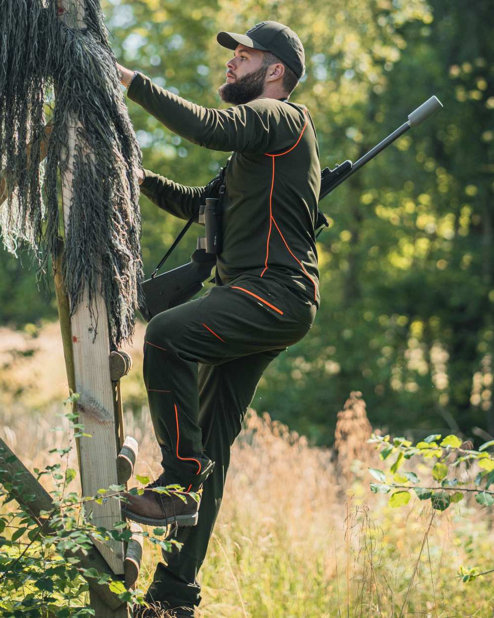 Forest Green coloured Deerhunter Chamois Trousers on forest background #colour_forest-green