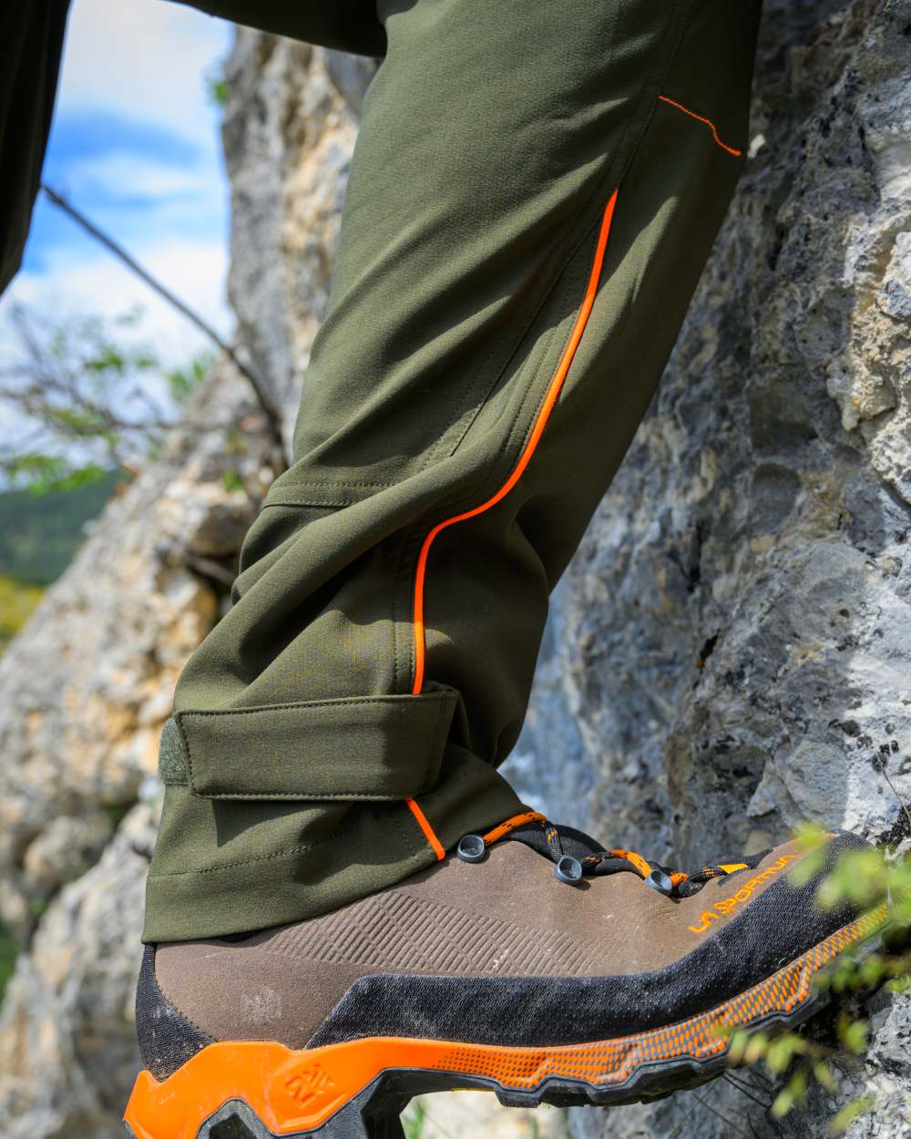Forest Green coloured Deerhunter Chamois Trousers on mountain background #colour_forest-green