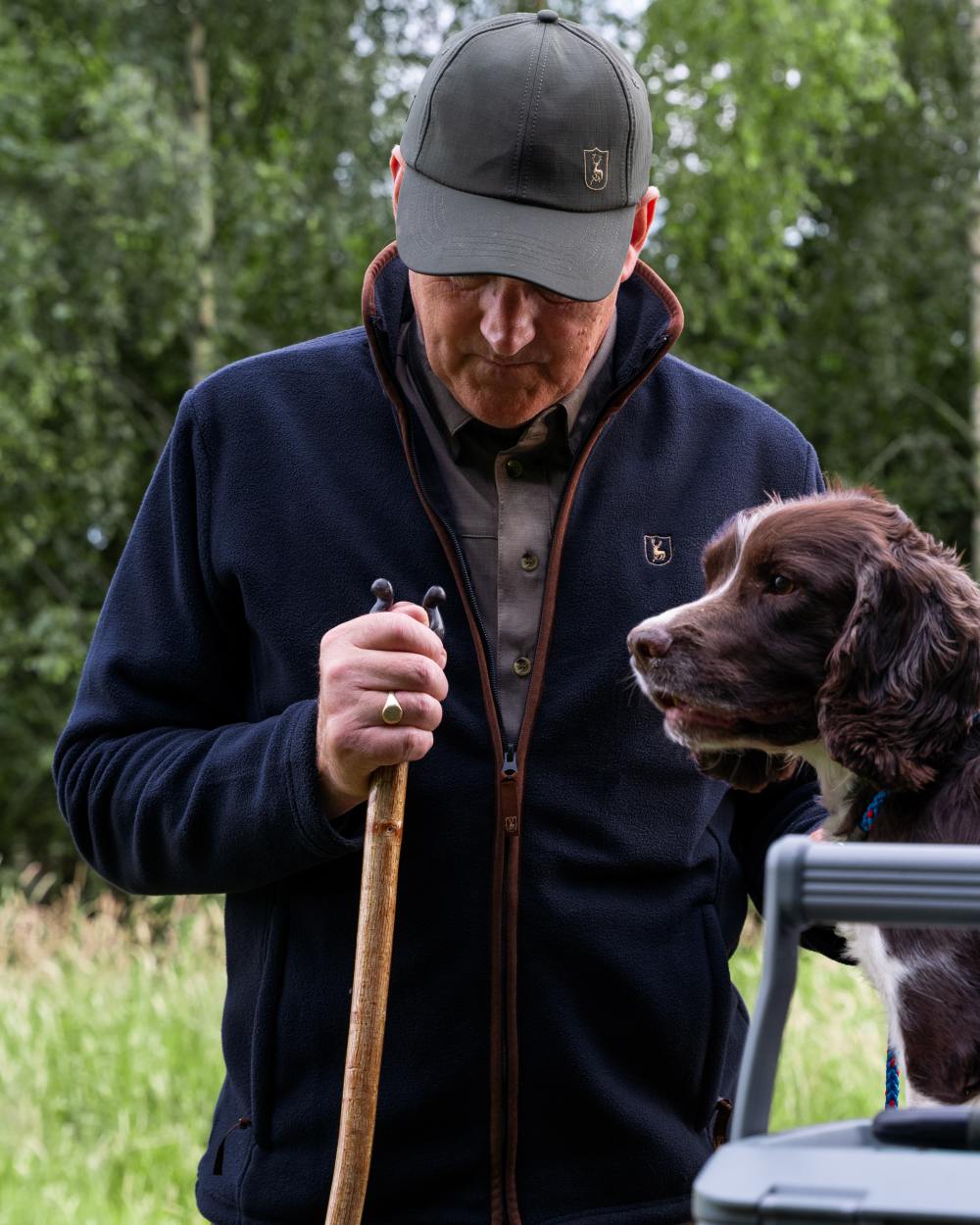 Dark Blue coloured Deerhunter Cumbria Fleece Jacket on forest background #colour_dark-blue