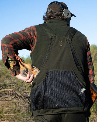 Forest Ember coloured Deerhunter Mens Cumbria Fleece Waistcoat on forest background #colour_forest-ember