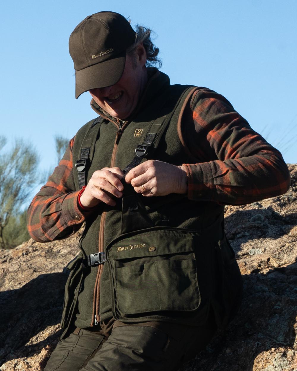Forest Ember coloured Deerhunter Mens Cumbria Fleece Waistcoat on forest background #colour_forest-ember