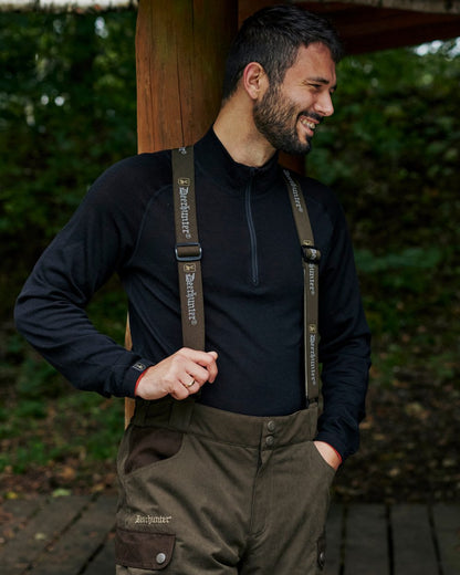 Tarmac Green Coloured Deerhunter Eagle Winter Trousers On A Forest Background #colour_tarmac-green