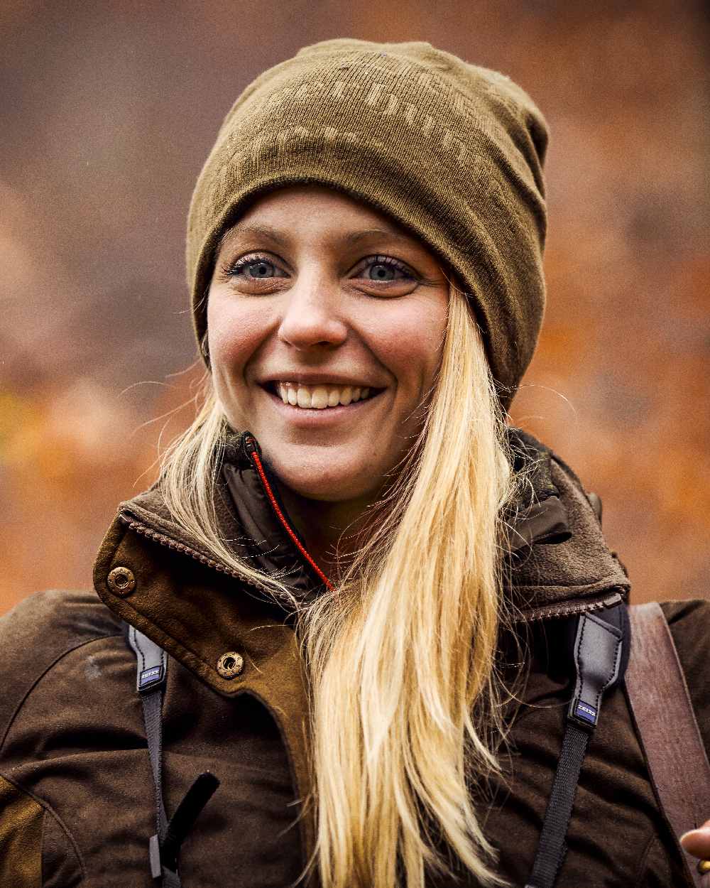 Tarmac Green coloured Deerhunter Embossed Logo Beanie on blurry background #colour_tarmac-green