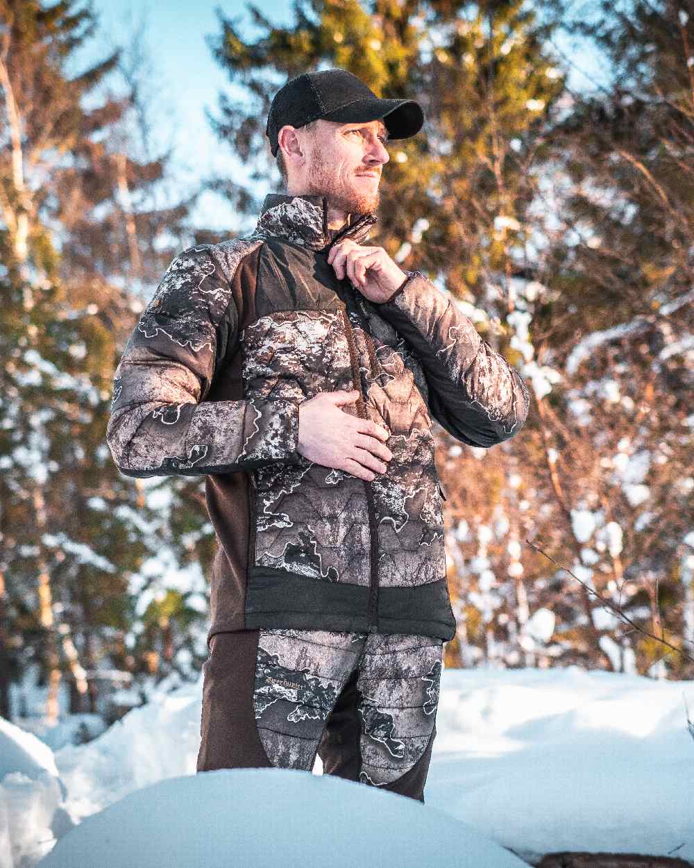 Realtree Excape coloured Deerhunter Excape Quilted Trousers on snow background #colour_realtree-excape