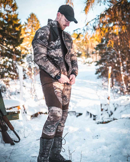 Realtree Excape coloured Deerhunter Excape Quilted Trousers on snow background #colour_realtree-excape