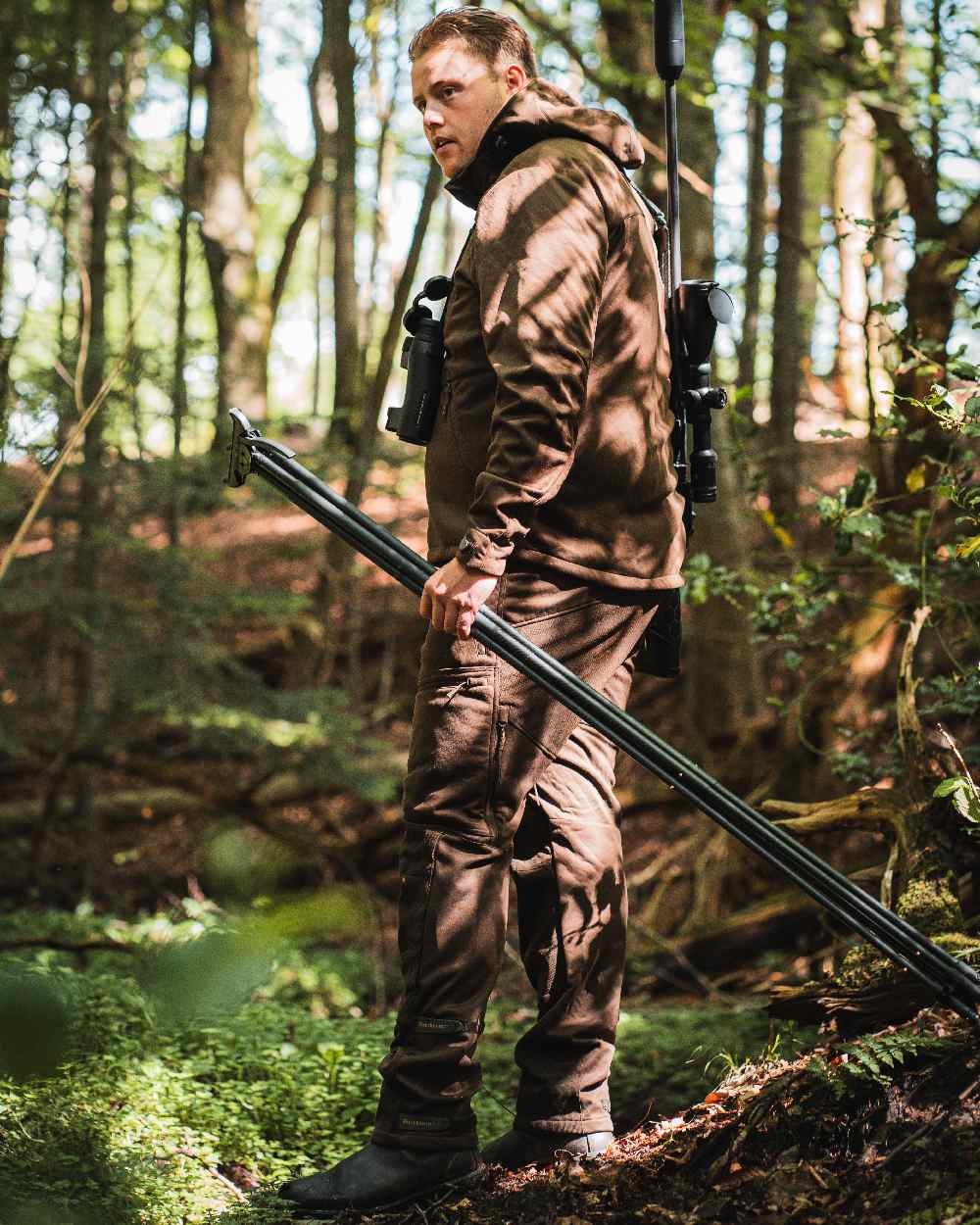 Art Green coloured Deerhunter Excape Softshell Jacket on forest background #colour_art-green